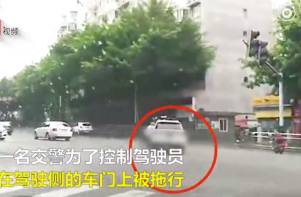 无法无天！女子驾车一路狂飙 交警挂车身上被拖行数百米
